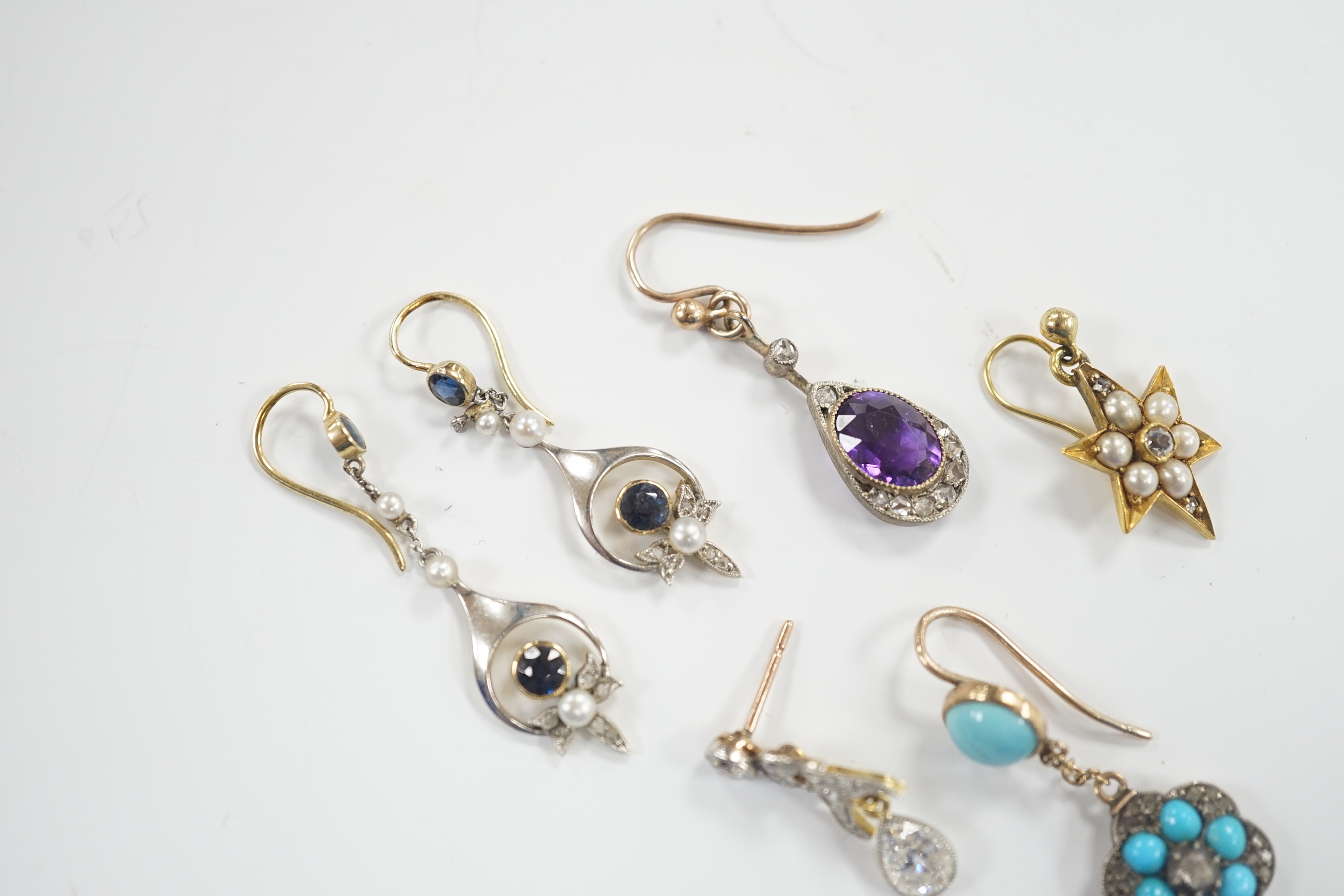 A group of four assorted Edwardian and later single earrings, including amethyst and diamond, turquoise and diamond, seed pearl and diamond cluster and pear shape diamond drop, 21mm and a pair of sapphire, seed pearl and